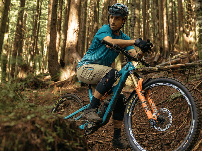 Cyclist riding in forest